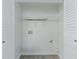 A compact laundry closet with white shelving, and utility hookups at 2335 Huntington Dr, Loganville, GA 30052