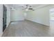 Open living room with gray wood-look floors, recessed lighting, and a ceiling fan; ideal for modern living at 2335 Huntington Dr, Loganville, GA 30052