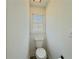 Clean, well-lit half bath featuring a modern toilet and a window at 2335 Huntington Dr, Loganville, GA 30052
