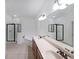 Well-lit bathroom features double sinks, a bathtub, and a glass door shower at 3692 Lambert Ne Ln, Brookhaven, GA 30319