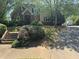 Traditional two-story home with brick and siding exterior, needing some TLC at 4504 Allen Hollow, Suwanee, GA 30024
