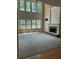 Large living room with two-story windows, fireplace, and built-in cabinets offers plenty of natural light at 4504 Allen Hollow, Suwanee, GA 30024