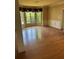 Spacious living room features hardwood floors, trim and large windows, offering great natural light at 4504 Allen Hollow, Suwanee, GA 30024