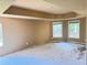 Spacious main bedroom with ample natural light, featuring a tray ceiling ready for renovation at 4504 Allen Hollow, Suwanee, GA 30024