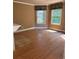 Well-lit room featuring hardwood floors, neutral wall colors and two large windows at 4504 Allen Hollow, Suwanee, GA 30024