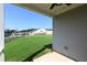 View of the grassy backyard from the covered patio, ideal for relaxing outdoors at 1057 Towne Mill Xing, Canton, GA 30114