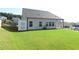Spacious backyard with lush green grass, privacy fence, and view of the house's rear exterior at 1057 Towne Mill Xing, Canton, GA 30114