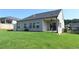 Backyard features a covered patio, large windows providing lots of light, and a grassy area at 1057 Towne Mill Xing, Canton, GA 30114