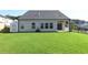 Lush, green backyard with an enclosed patio and a full view of the house's exterior at 1057 Towne Mill Xing, Canton, GA 30114