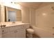 Bathroom featuring a white vanity, toilet, and shower over tub with tile surround at 1057 Towne Mill Xing, Canton, GA 30114