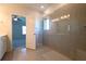 Bathroom boasts a large tiled shower with glass surround and doorway view into the bedroom at 1057 Towne Mill Xing, Canton, GA 30114