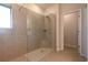 Spacious walk-in shower with clear glass door, neutral tile surround, and a view to the doorway at 1057 Towne Mill Xing, Canton, GA 30114