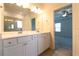 Bathroom features a double vanity and large mirror, with doorway view into the bedroom at 1057 Towne Mill Xing, Canton, GA 30114