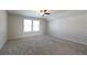 Bright, carpeted bedroom with two large windows and ceiling fan at 1057 Towne Mill Xing, Canton, GA 30114