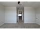 A light and bright bedroom with neutral carpeting and a view of a doorway to another room at 1057 Towne Mill Xing, Canton, GA 30114
