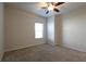 Carpeted bedroom offers a ceiling fan and natural light from the exterior window at 1057 Towne Mill Xing, Canton, GA 30114