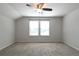 Bright bedroom featuring neutral carpeting, a ceiling fan, and natural light from two windows at 1057 Towne Mill Xing, Canton, GA 30114