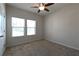 Bright bedroom featuring plush carpeting, ceiling fan, and ample natural light at 1057 Towne Mill Xing, Canton, GA 30114