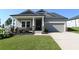 Charming home with gray siding, stone accents, manicured lawn, and attached garage at 1057 Towne Mill Xing, Canton, GA 30114