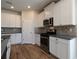 Well-equipped kitchen with ample cabinetry, stainless steel appliances, and tile backsplash at 1057 Towne Mill Xing, Canton, GA 30114