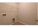 Neutral laundry room features white wire shelving and washer-dryer hookups at 1057 Towne Mill Xing, Canton, GA 30114