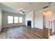 Spacious living room with a fireplace, fan, and beautiful wood floors at 1057 Towne Mill Xing, Canton, GA 30114