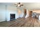 Open concept living room with hardwood floors connecting to the kitchen and staircase at 1057 Towne Mill Xing, Canton, GA 30114