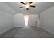 Bright, carpeted loft area leading to bathroom and stairs at 1057 Towne Mill Xing, Canton, GA 30114