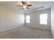 Inviting main bedroom features a tray ceiling, ceiling fan, and neutral walls at 1057 Towne Mill Xing, Canton, GA 30114