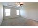 Inviting main bedroom features a tray ceiling, ceiling fan, and neutral walls at 1057 Towne Mill Xing, Canton, GA 30114