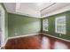 Spacious bedroom featuring green walls, tray ceiling, hardwood floors and bright natural light at 2601 Brandenberry Dr, Decatur, GA 30034