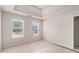 This bedroom has large windows, carpet, and a tray ceiling at 2601 Brandenberry Dr, Decatur, GA 30034