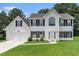 Charming two-story home with white siding, black shutters, and a well-manicured front lawn at 2601 Brandenberry Dr, Decatur, GA 30034