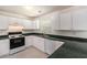 Functional kitchen with white cabinets, black appliances, and green countertops, offering ample cooking space at 2601 Brandenberry Dr, Decatur, GA 30034