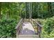Wooden bridge leading to a wooded area can be seen at 2500 Ashbourne Dr, Lawrenceville, GA 30043