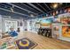 Finished basement with laminate flooring, recessed lighting, wall decor, and built-in shelving at 2500 Ashbourne Dr, Lawrenceville, GA 30043