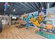Expansive finished basement with laminate flooring, sports decor, a bar area, and workout space at 2500 Ashbourne Dr, Lawrenceville, GA 30043