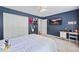 Bedroom with plush carpet, white closet doors, and blue walls at 2500 Ashbourne Dr, Lawrenceville, GA 30043