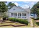 Elegant clubhouse featuring a spacious wraparound porch and manicured landscaping at 2500 Ashbourne Dr, Lawrenceville, GA 30043