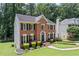 Two-story brick home with neatly manicured lawn and mature trees at 2500 Ashbourne Dr, Lawrenceville, GA 30043