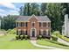 Charming brick home boasts a manicured lawn, black shutters, and a welcoming front entrance at 2500 Ashbourne Dr, Lawrenceville, GA 30043