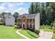 Well-maintained brick home with lush green lawn and established landscaping at 2500 Ashbourne Dr, Lawrenceville, GA 30043