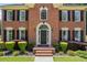 Close-up of brick home's entryway, showcasing front door and landscaping at 2500 Ashbourne Dr, Lawrenceville, GA 30043
