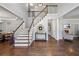 Open foyer with hardwood floors, staircase, and views into adjacent living spaces at 2500 Ashbourne Dr, Lawrenceville, GA 30043