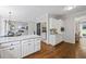 Well-lit kitchen space with marble countertops, white cabinetry, and wood floors at 2500 Ashbourne Dr, Lawrenceville, GA 30043