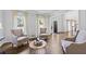 Bright and airy living room with hardwood floors and three chairs at 2500 Ashbourne Dr, Lawrenceville, GA 30043