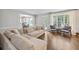 Comfortable living room with hardwood floors, neutral paint, and views into the kitchen and outdoor area at 2500 Ashbourne Dr, Lawrenceville, GA 30043