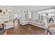 Spacious living room with hardwood floors, built-in bookshelves, and views into the kitchen and dining area at 2500 Ashbourne Dr, Lawrenceville, GA 30043