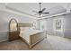 Main bedroom features a trey ceiling, fan, carpet, and light colored walls and trim at 2500 Ashbourne Dr, Lawrenceville, GA 30043