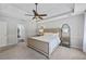 Spacious main bedroom with trey ceiling, fan, carpet, bedside tables and neutral decor at 2500 Ashbourne Dr, Lawrenceville, GA 30043